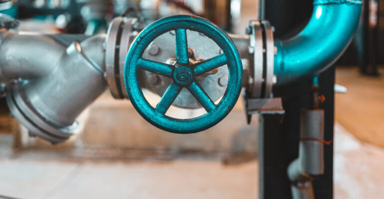 This picture features an industrial heating plant, showing the smokestacks in the background